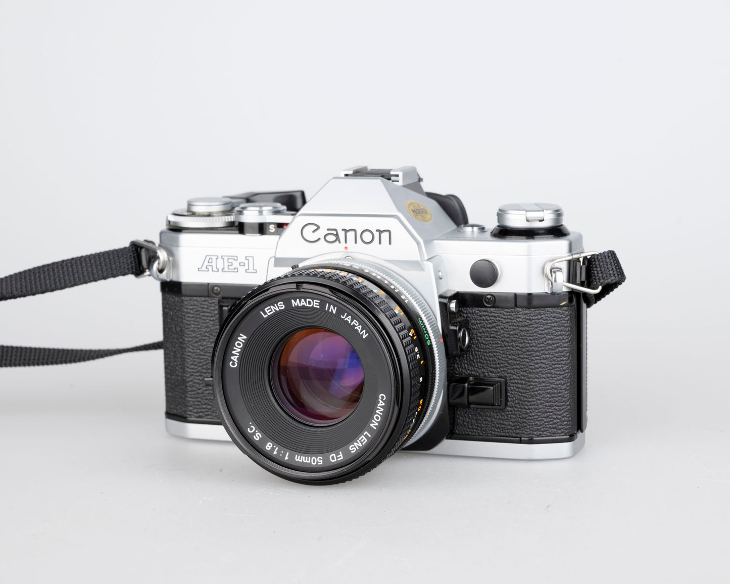 Canon AE-1 35mm SLR w/ Canon FD 50mm f1.8 lens + Speedlite 188A flash + original manual (serial 2388361)