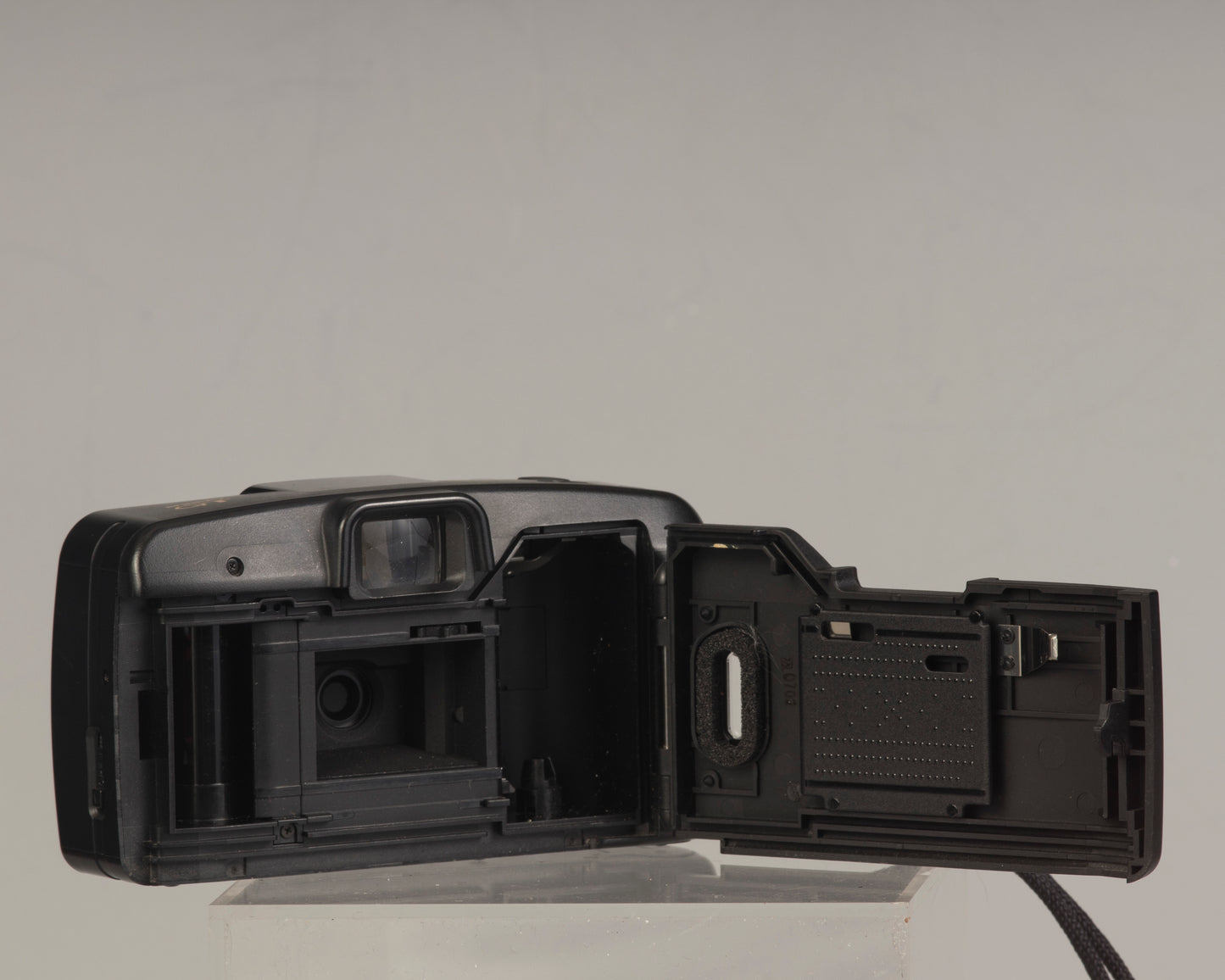 The Canon Snappy QT (shown here with film door open) is a 35mm film point-and-shoot camera featuring a 32mm lens and an unusually large and bright viewfinder.