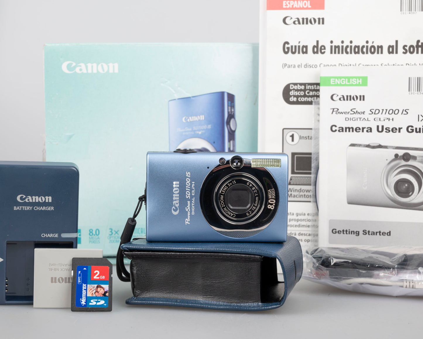Canon Powershot SD1100 IS Digital Elph 8MP CCD digicam w/ 2GB SD card + batteries + charger + original box + case