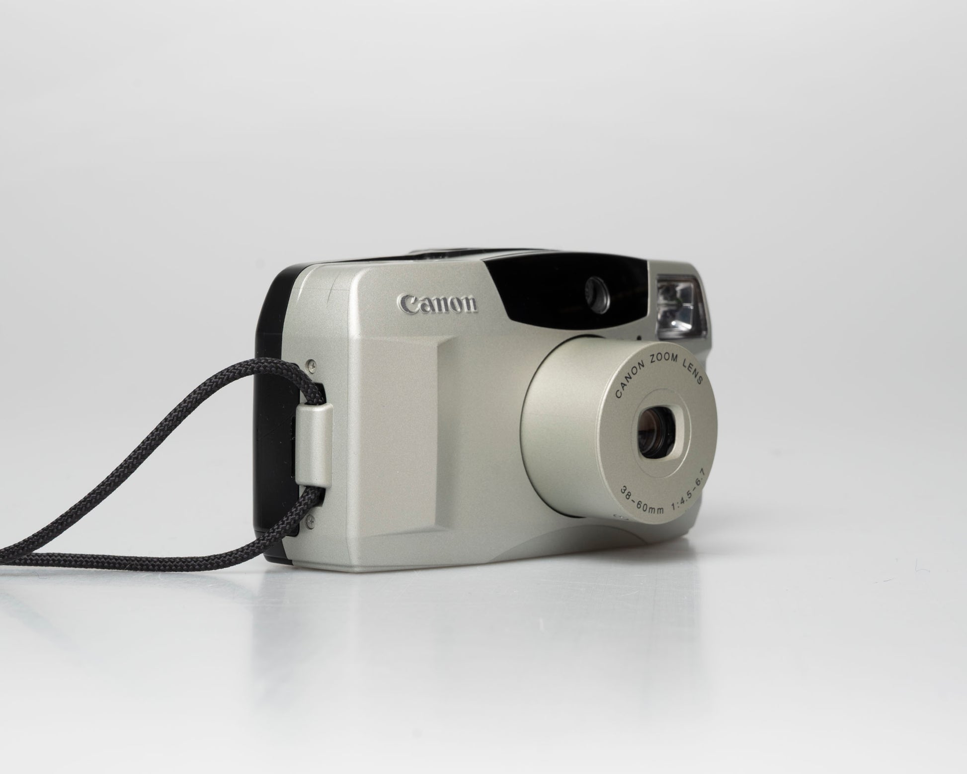 Canon Sure Shot 60 Zoom 35mm point-and-shoot camera; left angle zoomed out