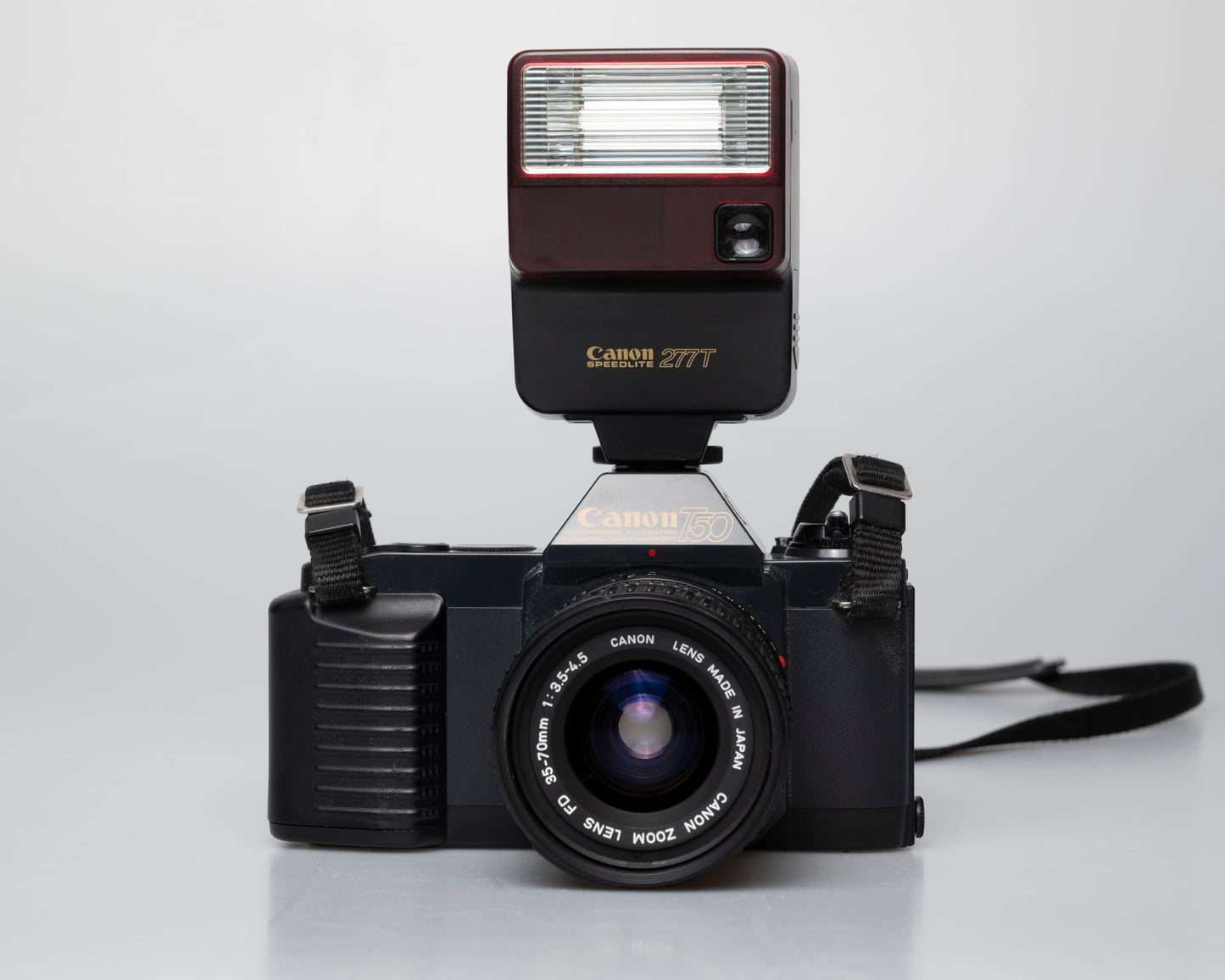 Canon T50 35mm film SLR camera w/ FD 35-70mm lens + Speedlite 277T flash + ever-ready case (serial 1061065)