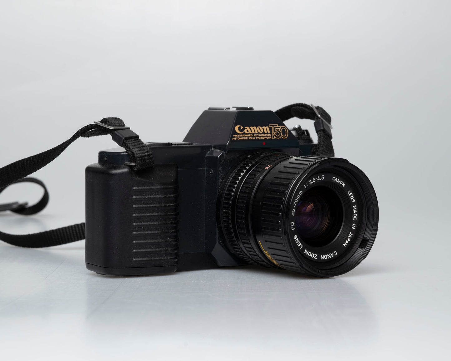 Canon T50 35mm film SLR camera w/ FD 35-70mm lens + Speedlite 277T flash + ever-ready case (serial 1061065)