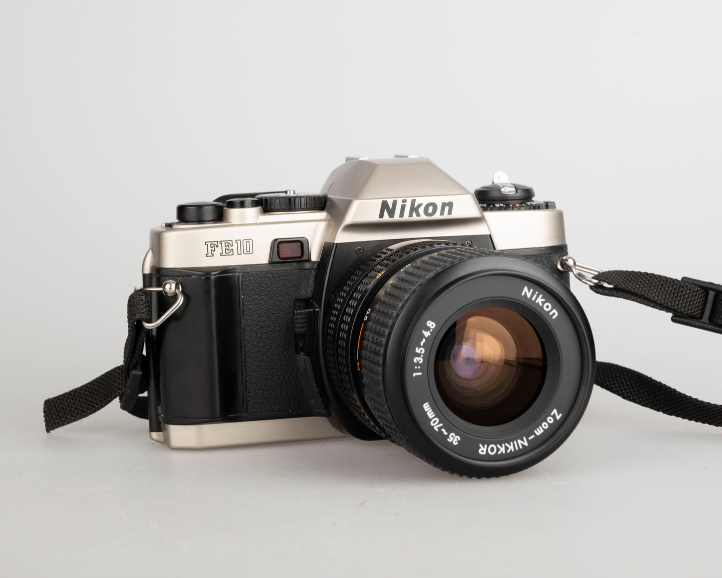 Nikon FE10 35mm film SLR camera w/ Zoom-Nikkor 35-70mm lens + ever-ready case (serial 2001252)