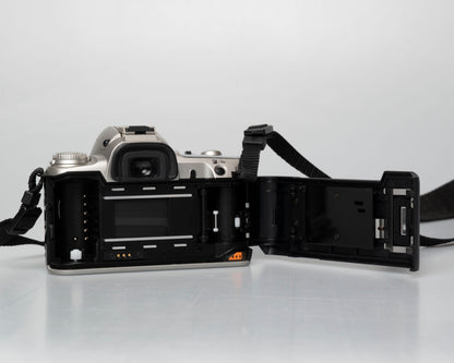 Pentax MZ-50 35mm film camera with kit zoom lens; rear view with film door open