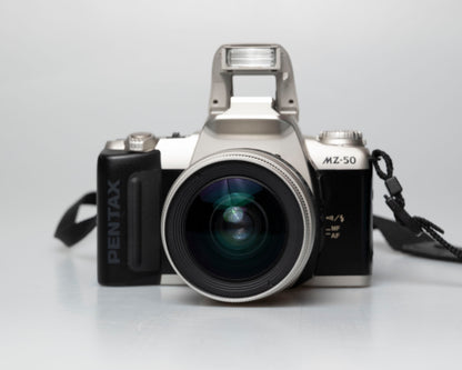 Pentax MZ-50 35mm film camera with kit zoom lens; front view with pop-up flash showing
