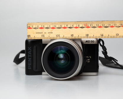 Pentax MZ-50 35mm film camera with kit zoom lens; front view with ruler for scale
