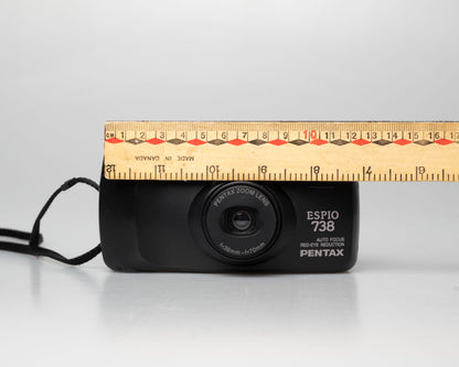 Pentax Espio 738 (aka IQZoom Ezy) compact 35mm film point-and-shoot camera; front view lens cover open with ruler for scale