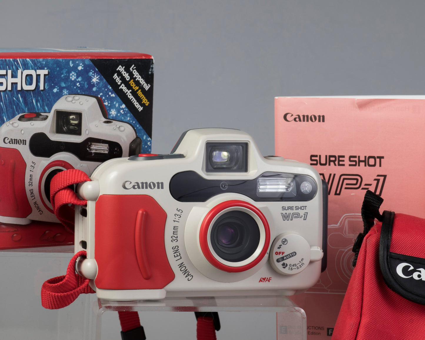 The Canon Sure Shot WP-1 waterproof 35mm camera (shown with box, case, and manual)