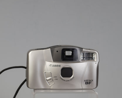 The Canon Sure Shot BF is a compact 35mm point-and-shoot with an unually large and bright viewfinder (shown here with the lens cap closed)