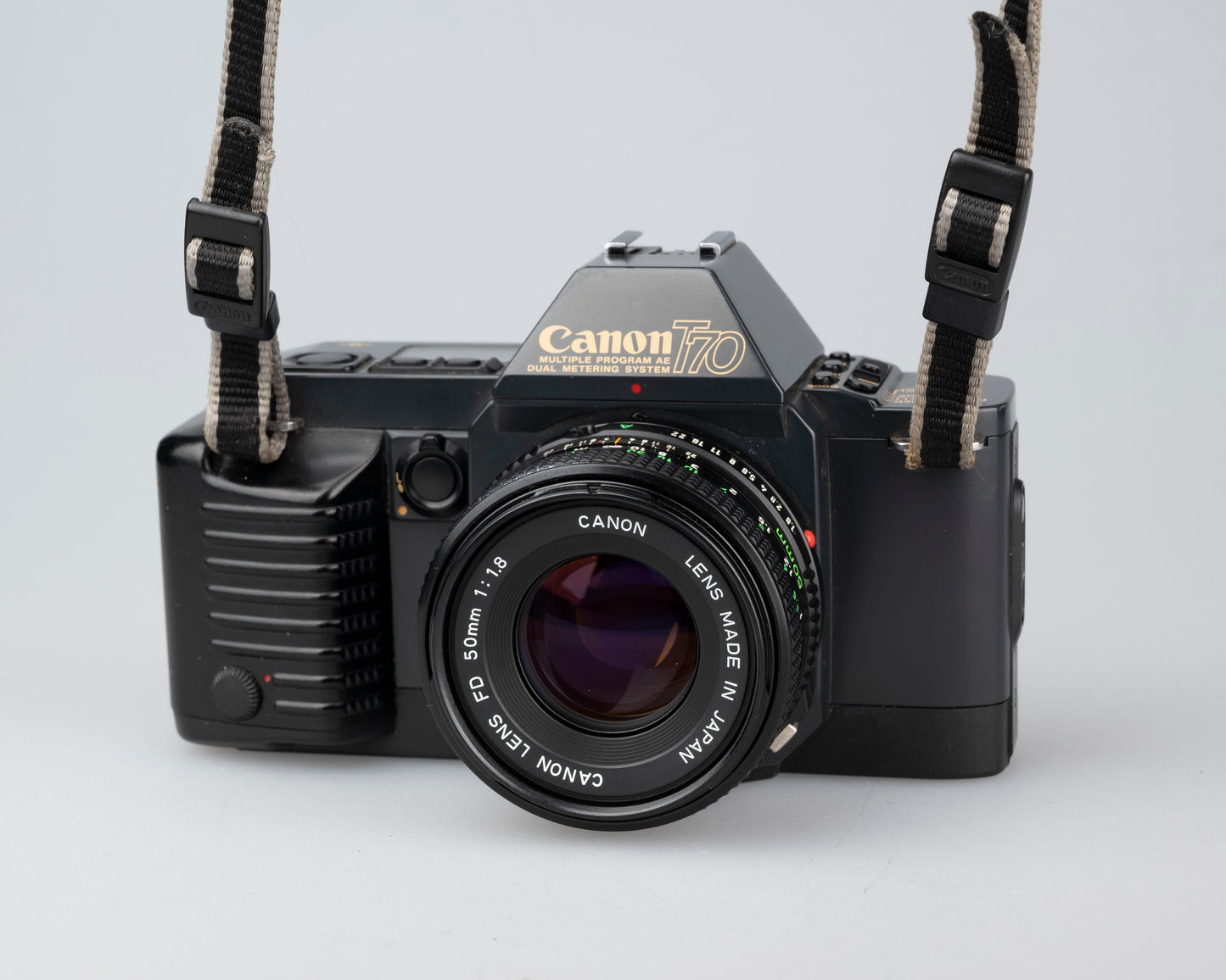 The Canon T70 35mm SLR camera  with FD 50mm f1.8 lens. This film-tested camera is available at www.newwavepool.shop 