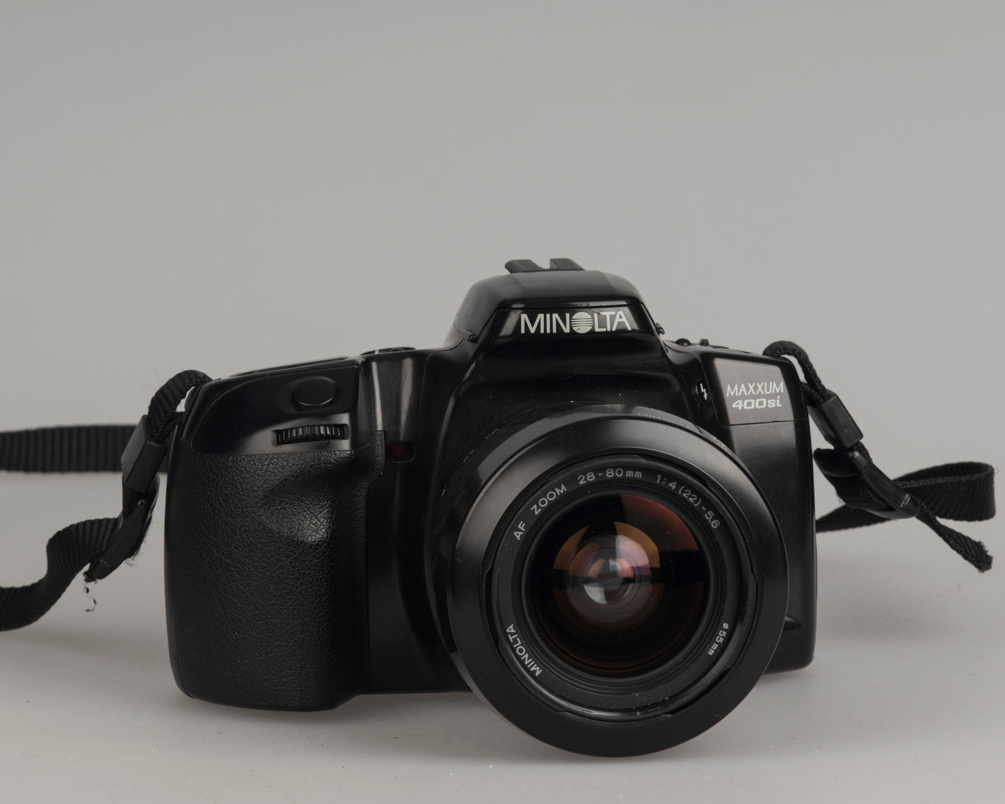 Minolta Maxxum 400si 35mm film SLR camera featuring a 28-80mm lens; front left view