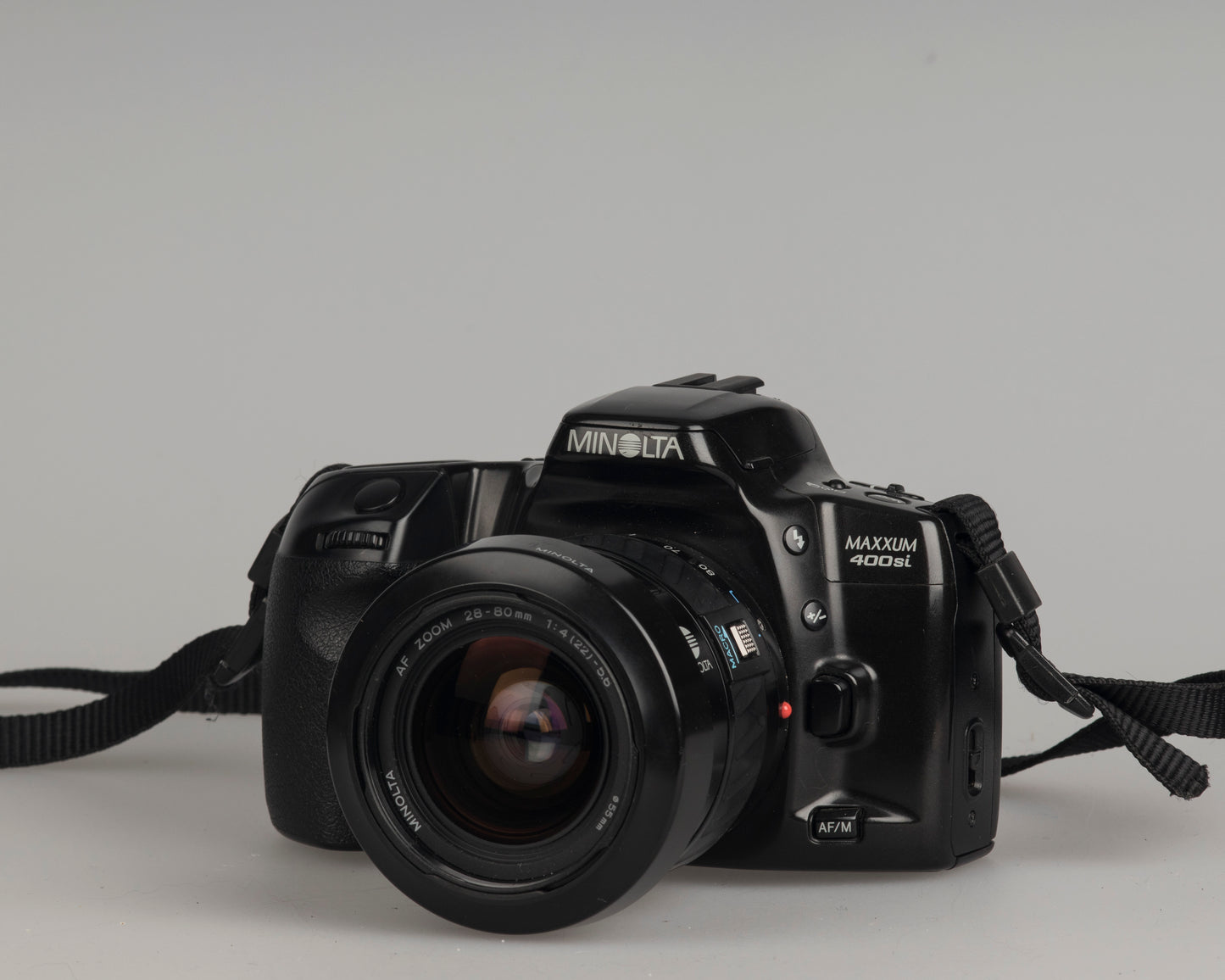 Minolta Maxxum 400si 35mm film SLR camera featuring a 28-80mm lens; front view