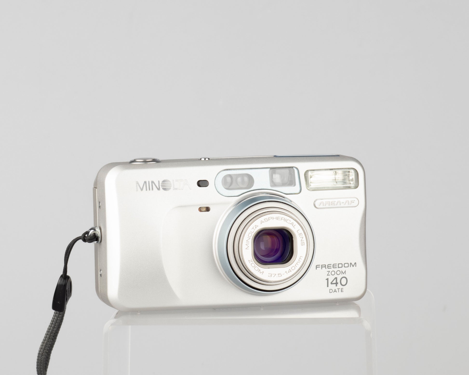 The Minolta Freedom Zoom 140 Date is a sophisticated compact 35mm point-and-shoot from 2001 featuring the innovative 'Area AF' autofocusing design
