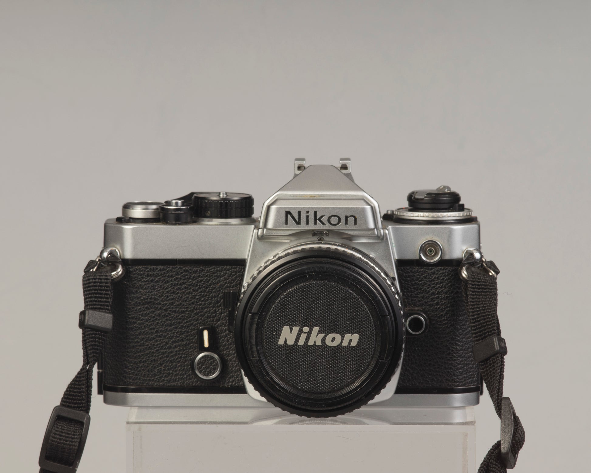 Nikon FE 35mm film SLR camera with Nikon E 50mm f1.8 lens. Available at New Wave Pool, Montreal.