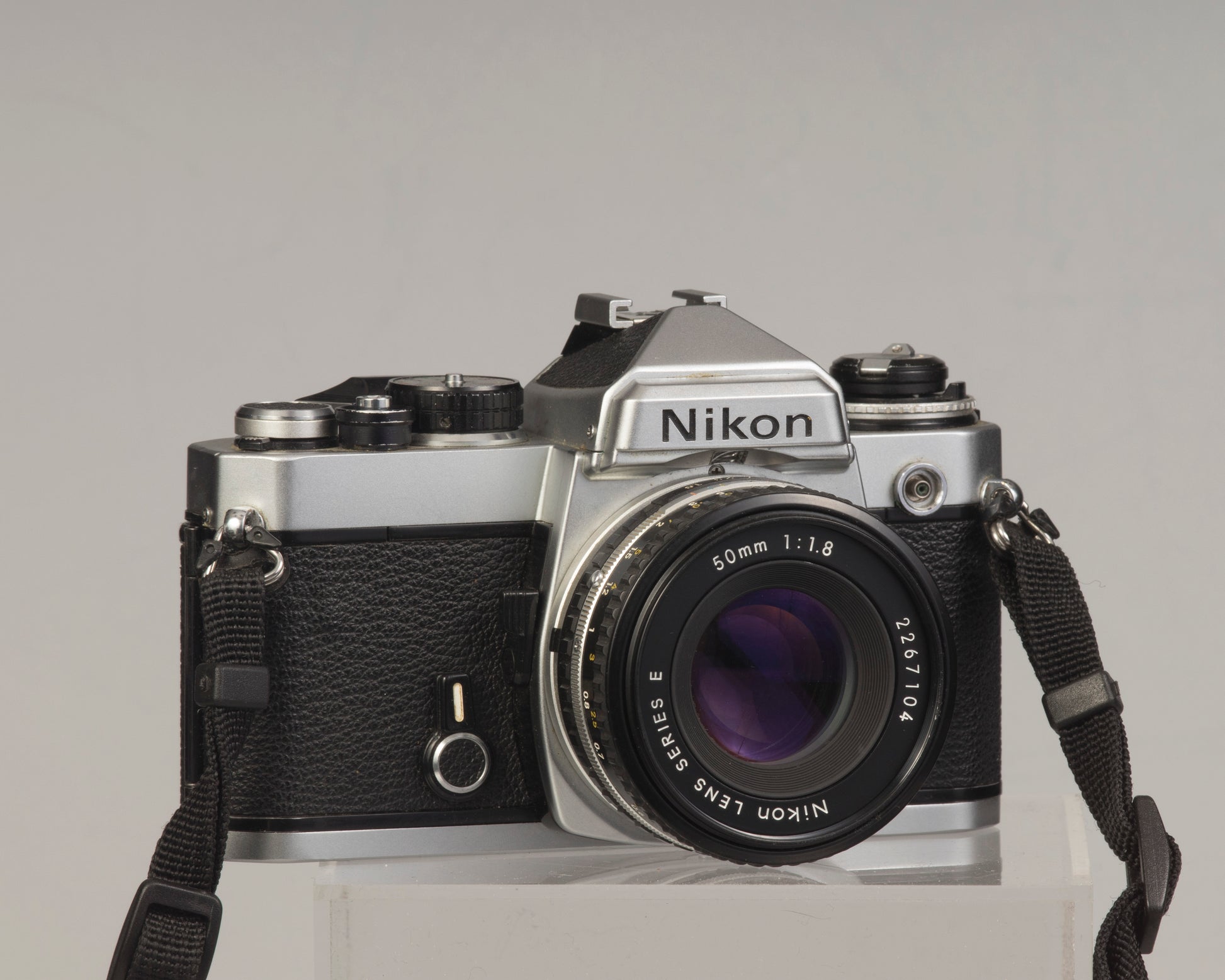 Nikon FE 35mm film SLR camera with Nikon E 50mm f1.8 lens. Available at New Wave Pool, Montreal.