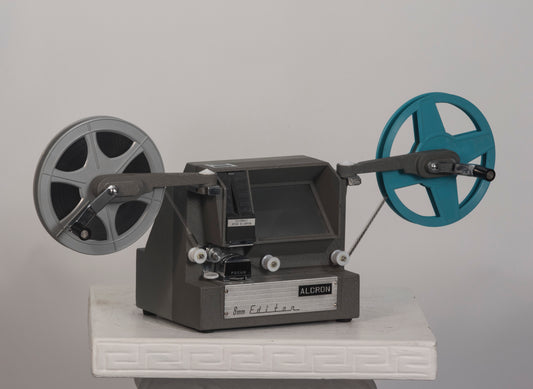 Alcron 8mm movie viewer/editor shown with reel