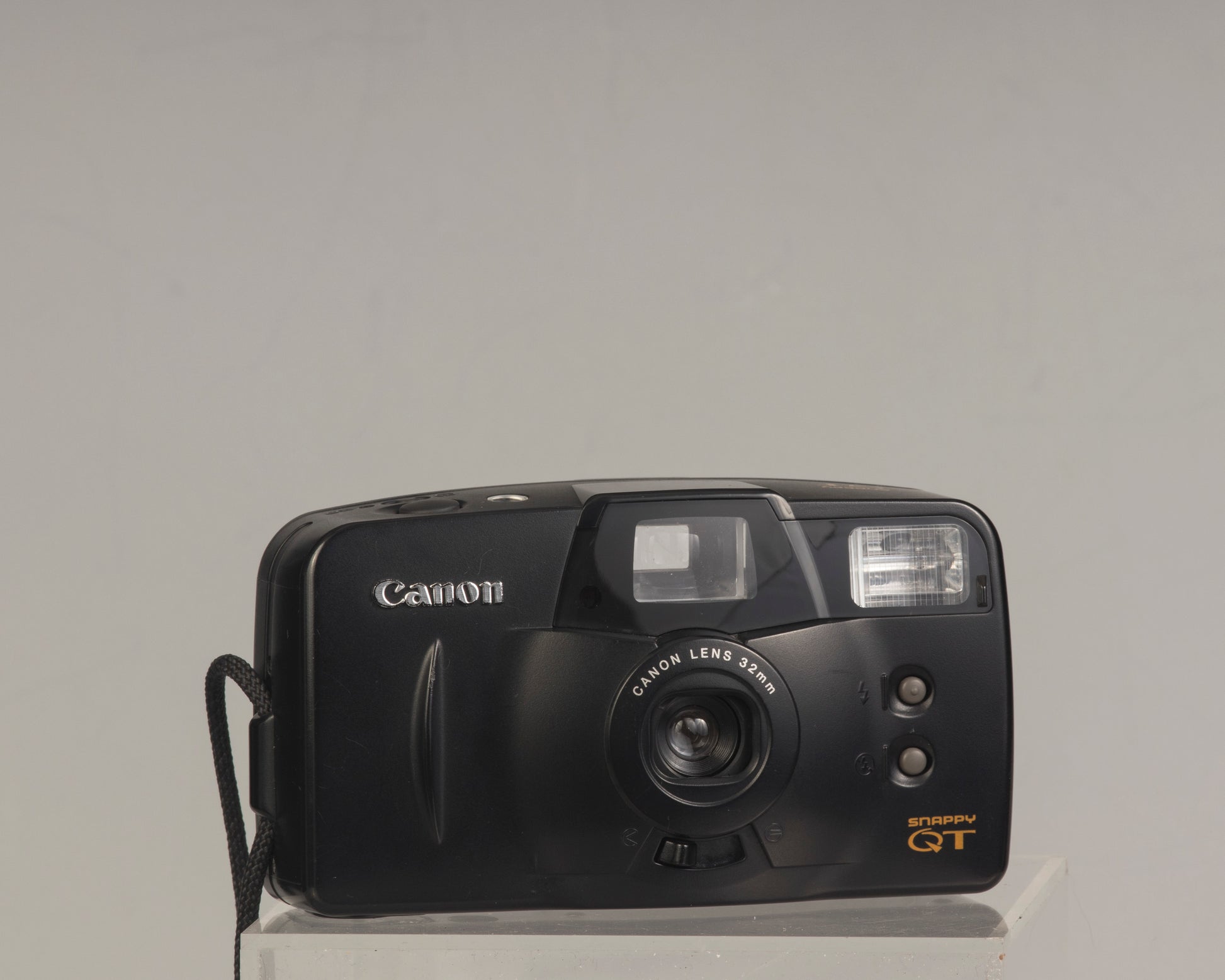 The Canon Snappy QT is a 35mm film point-and-shoot camera featuring a 32mm lens and an unusually large and bright viewfinder.