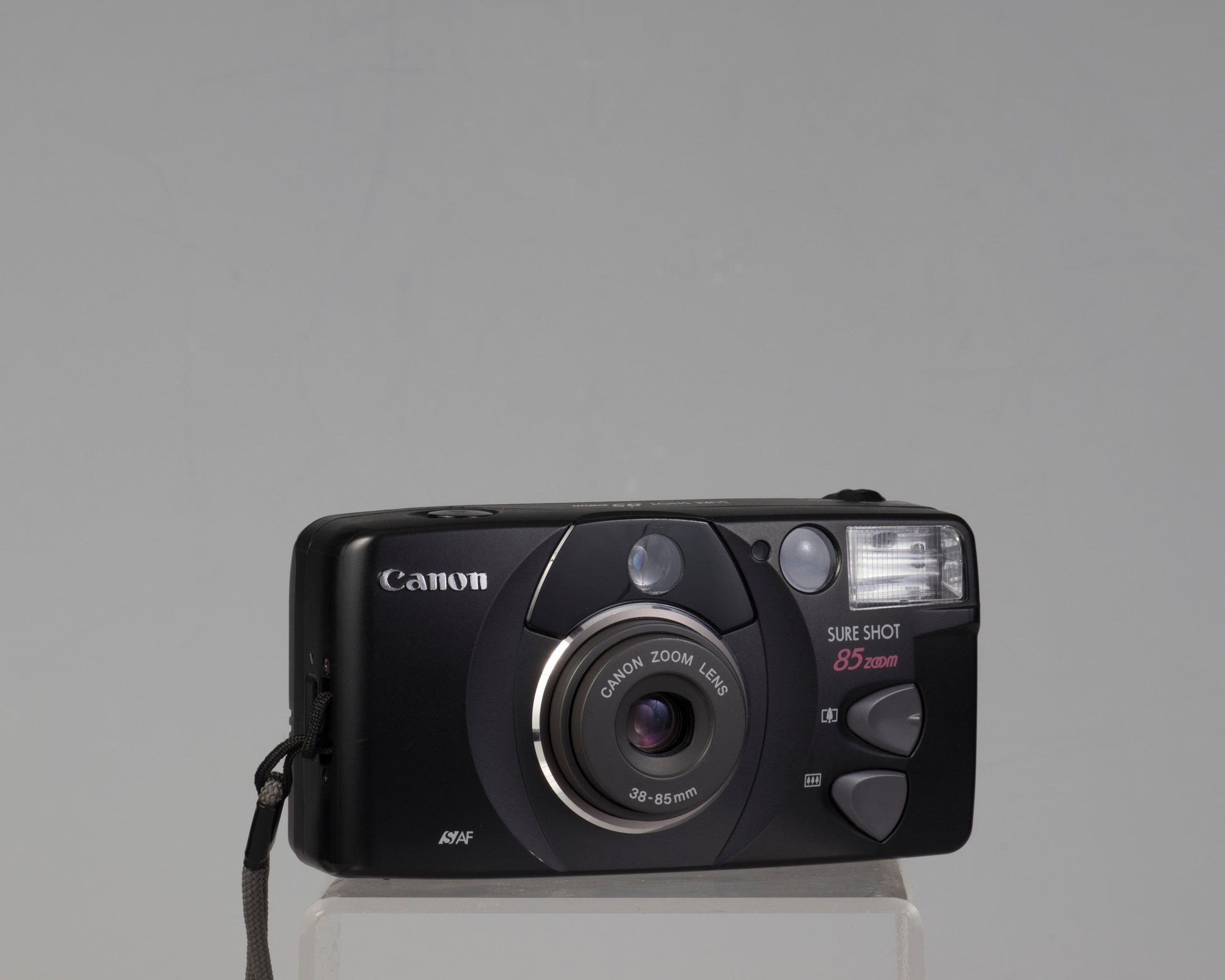 The Canon Sure Shot Zoom 85 (black) is a compact 35mm camera from the late 1990s