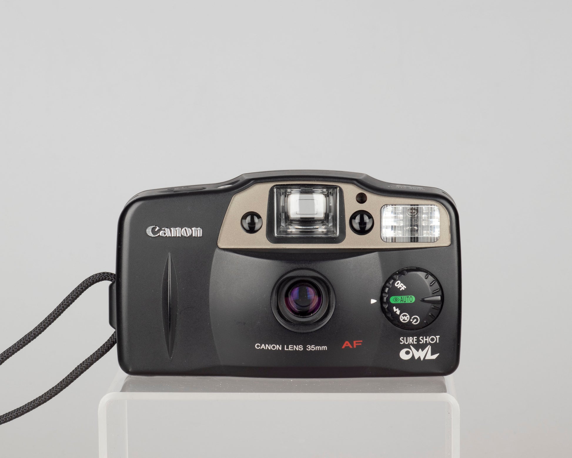 The Canon Sure Shot Owl is a classic 1990s 35mm autofocus point-and-shoot camera with a very user-friendly mode dial