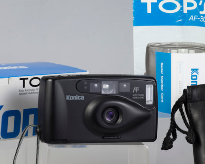 The Konica TOP'S AF-300 compact 35mm camera, shown here with its original box, manual and case.