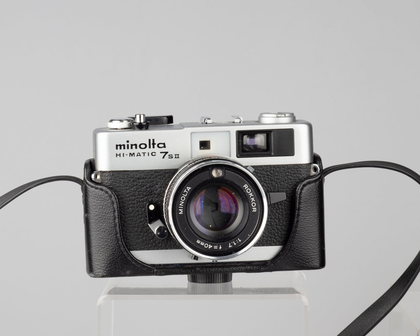 Minolta Hi-Matic 7SII 35mm rangefinder camera with half-case and Minolta 20 flash