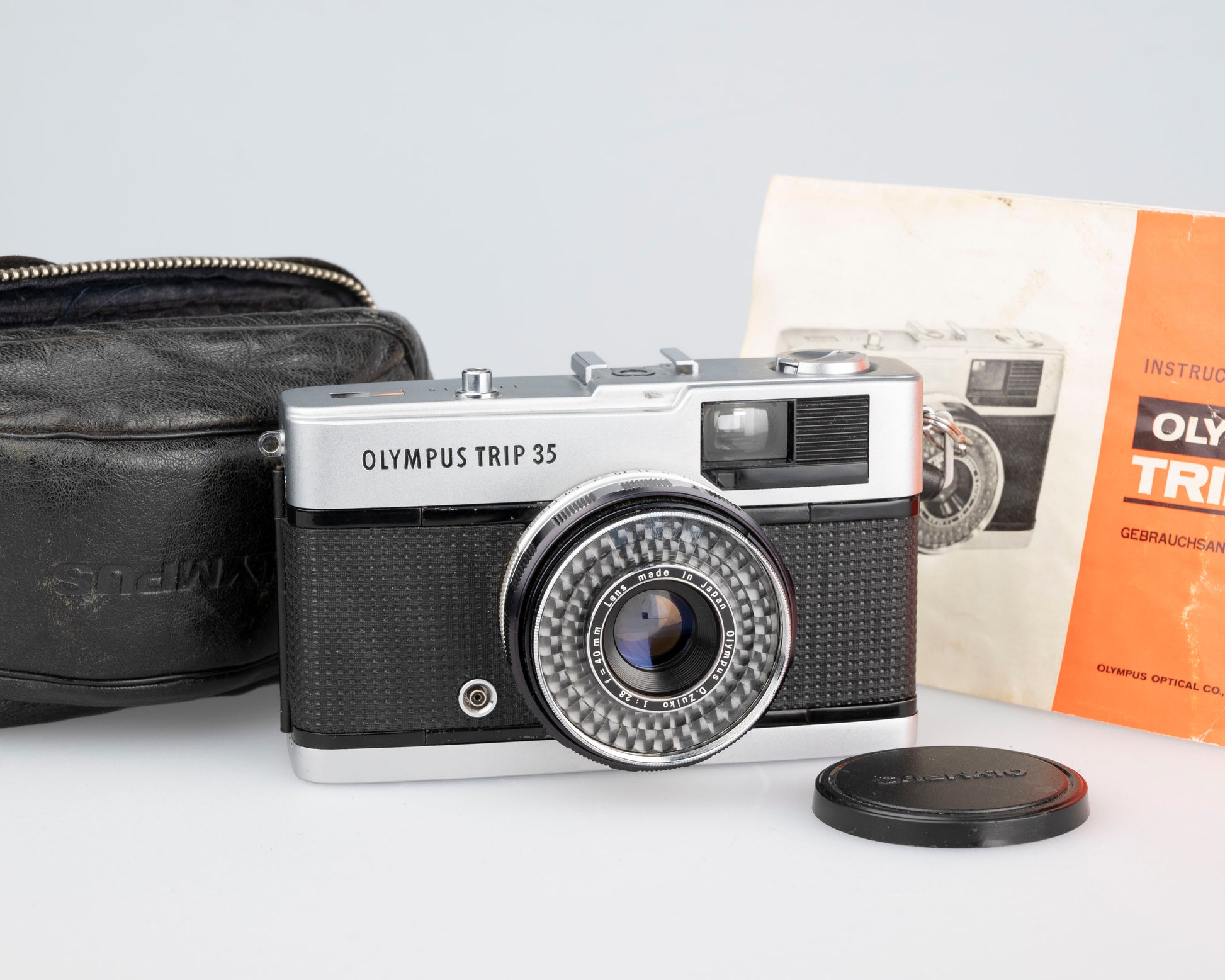 This is an Olympus Trip 35 with its original leather case and user manual