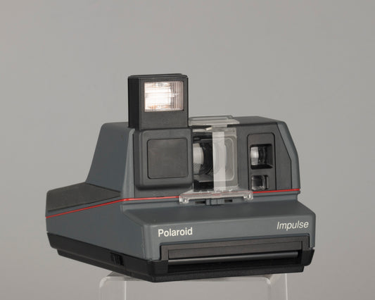 Polaroid Impulse instant camera with original case, prism lens filter, box, and manual