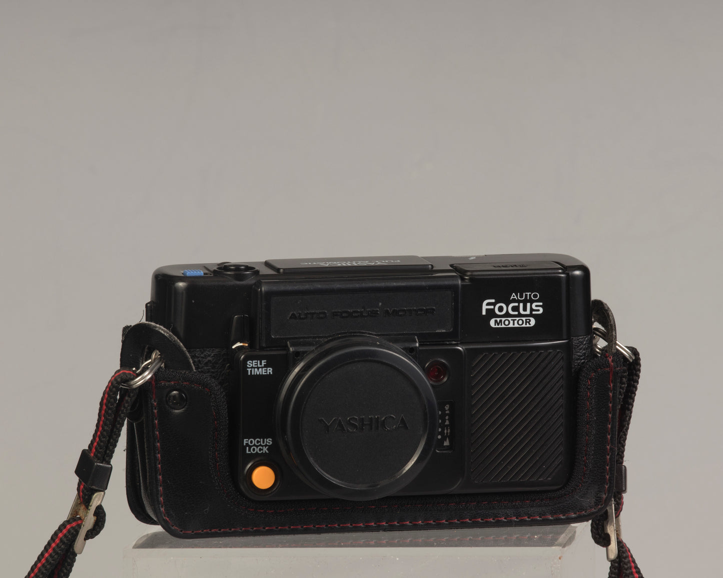 The Yashica Auto Focus Motor (shown with lens cap on) is a classic 35mm point-and-shoot film camera featuring a 38mm f2.8 lens