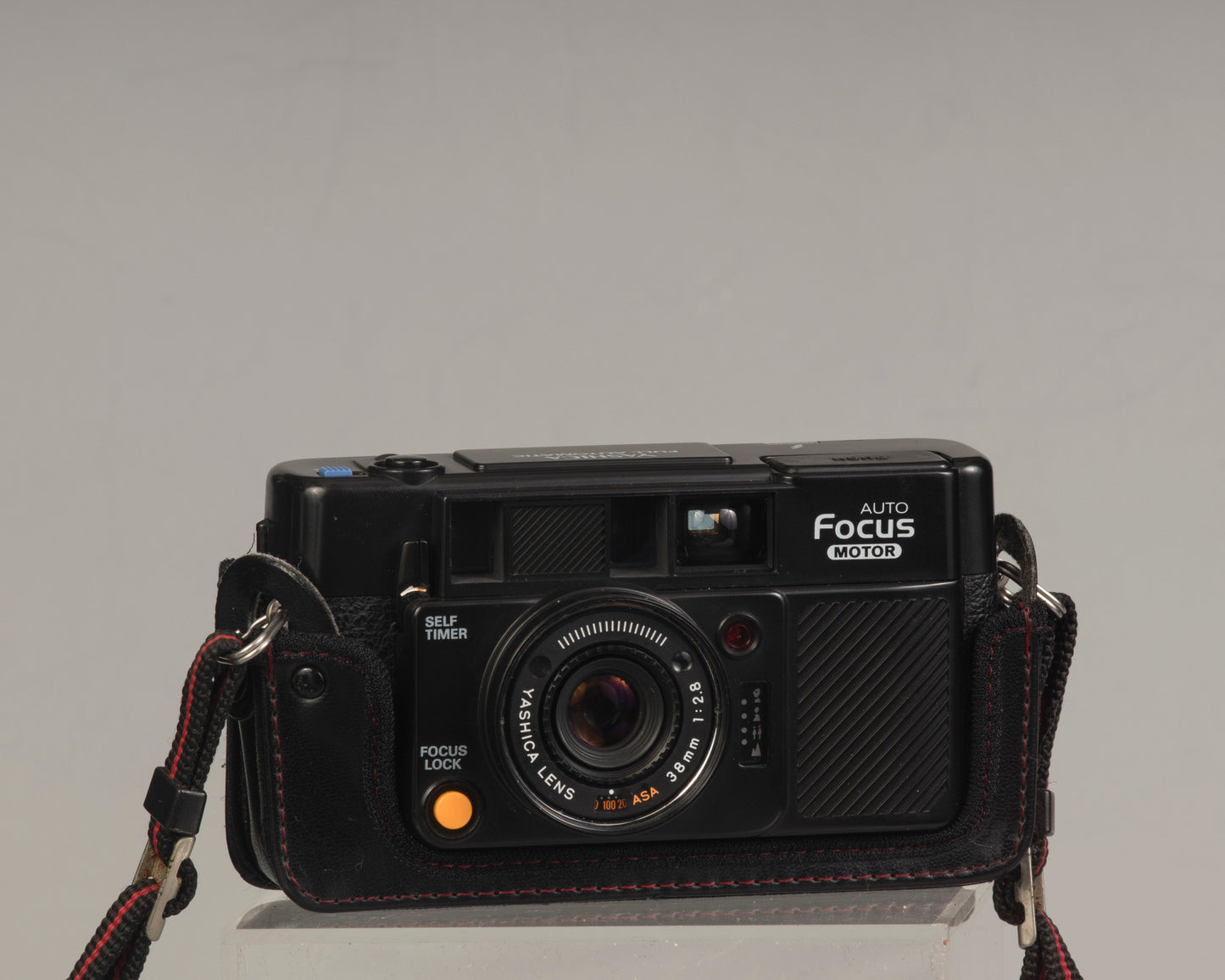 The Yashica Auto Focus Motor (shown in half-case) is a classic 35mm point-and-shoot film camera featuring a 38mm f2.8 lens